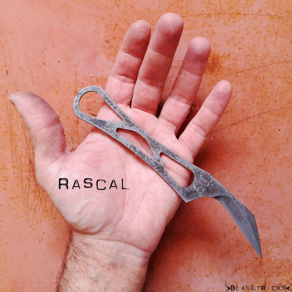 Bladetricks Rascal held in an open palm, a one-piece skeletonised steel tool with a wide flat handle and a hooked blade.